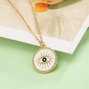 Detail of gold-plated evil eye pendant with white enamel and sparkling zircon accents
