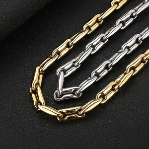 Macro shot of gold and silver coffee bean link chains with polished finish