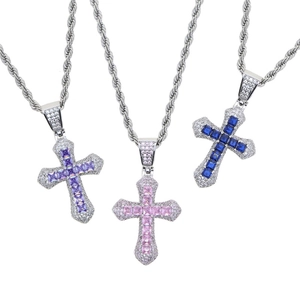 Detail of silver cross necklaces with purple, pink, and blue zircon gemstones