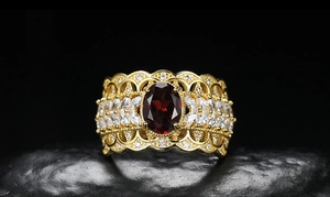 Macro shot of retro S925 silver ring with red garnet and white topaz on stone