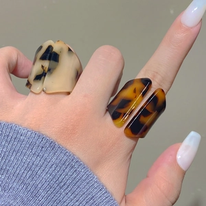 Close-up of retro acrylic leopard print rings with tortoise shell textures for women