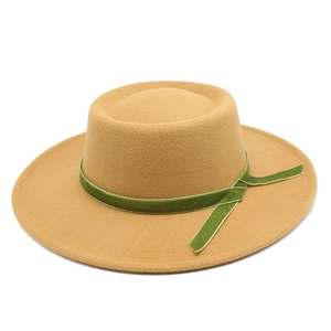 Macro detail of camel wool felt fedora featuring an olive green velvet decorative ribbon