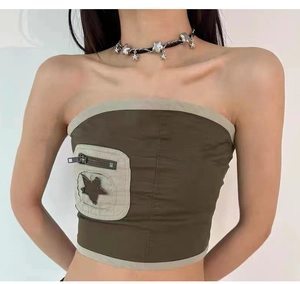 Close-up of brown Y2K tube top featuring beige pocket with zipper and star patch detail