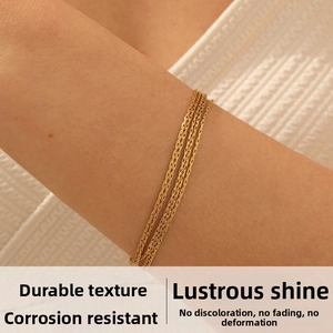 Macro shot of layered gold plated stainless steel multi-strand bracelet on wrist