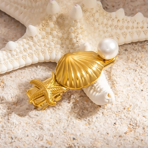 18k gold shell and starfish hair clip with white pearl on white sand beach