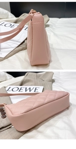 Detail view of pink quilted faux leather shoulder bag with side and bottom stitching