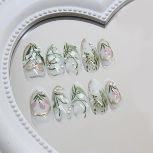 Elegant 3D floral press-on nails with pearls and gold lines on a heart-shaped mirror