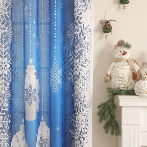 Detail of Christmas curtain featuring large white snowflakes and glowing lantern patterns
