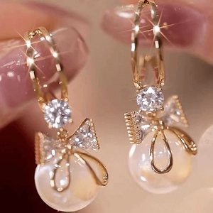 Elegant gold bow earrings with pearls and crystals in a festive Chinese style