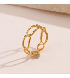 Detail shot of golden hollow chain link ring with adjustable open band texture