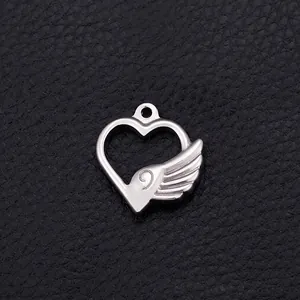 Silver stainless steel heart wing pendant for DIY jewelry making on black leather background