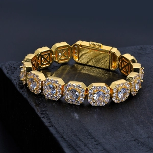 Close-up of gold hip-hop square link bracelet with cubic zirconia on dark stone