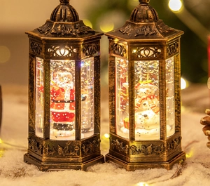 Detail of vintage bronze Christmas lanterns with warm LED lights and holiday figurines