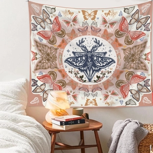 Bohemian butterfly tapestry hanging above a cozy bed with vintage antler design elements