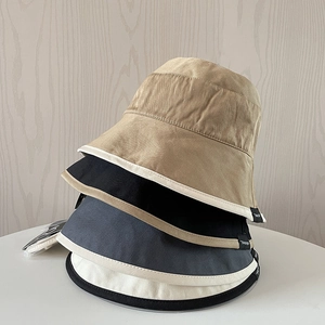 Detail of cotton bucket hats in four colors with high-quality twill texture and logo labels