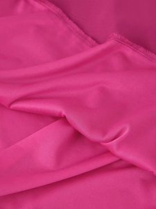 Detailed macro view of soft rose red knitted fabric with elegant mesh texture