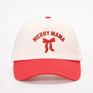 Detailed close-up of Merry Mama embroidery and bow on a two-tone baseball cap