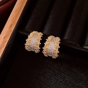 Macro detail of 14K gold plated C-shaped earrings with micro-pave cubic zirconia stones