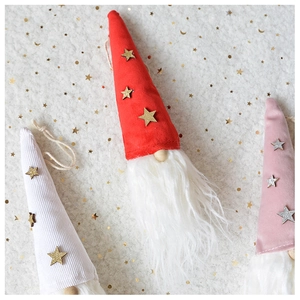 Close-up of plush Christmas gnome ornaments with sequined hats and long white beards