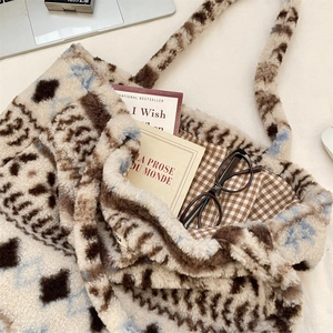 Detail of plush tote bag showing soft sherpa texture and brown checkered fabric lining