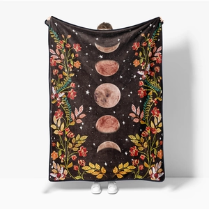 Artistic flannel blanket with moon phases and floral patterns shown in full display