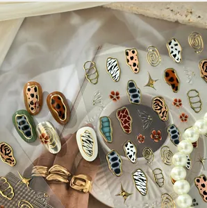 Detailed animal print nail stickers with metallic gold edges and leopard patterns