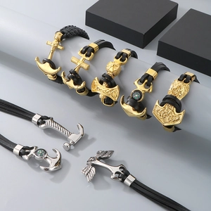 Detail of Viking Thor hammer and anchor charms on black braided leather bracelets