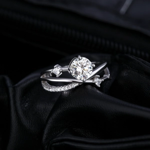 Luxurious crisscross moissanite ring with round center stone and pave diamond accents