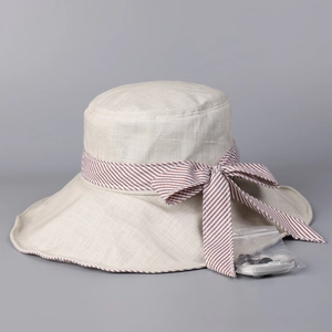 Detail of sun hat showing striped bow ribbon and detachable windproof chin strap