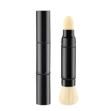 Close-up of dual-ended makeup brush with sponge head and soft flat concealer bristles
