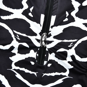 Detailed close-up of a high-quality silver metal zipper on leopard print dress fabric