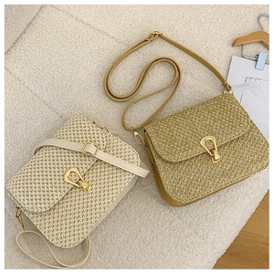Close-up of woven crossbody bags in beige and khaki with elegant gold waterdrop buckles