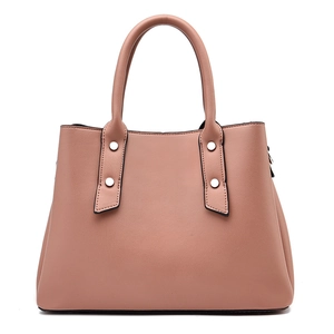 Elegant mauve leather tote bag with silver rivets and dual handles on white background