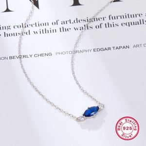 Macro view of blue marquise-cut zircon pendant on a 925 sterling silver chain