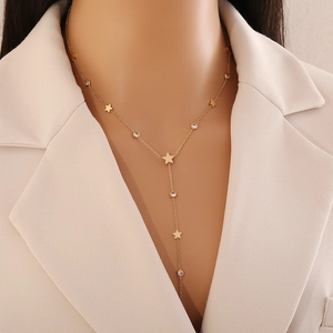Elegant gold Y-shaped titanium necklace with stars and zircons worn on a model