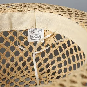 Women's wide brim raffia straw hat with adjustable drawstring and hollow weave design
