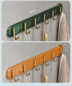 Detail showing orange and green wall-mounted 6-hook racks with gold accents, 42cm length