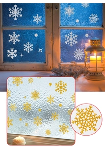 Macro detail of gold and silver snowflake window decals for festive glass decoration