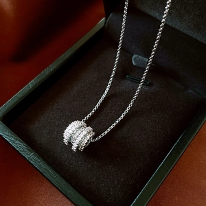 Macro shot of silver Tubogas style pendant necklace with paved zircon on velvet box