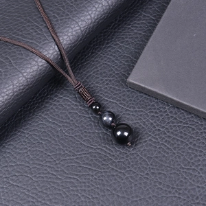 Close-up of a 16mm natural tiger eye stone pendant with an adjustable brown braided cord