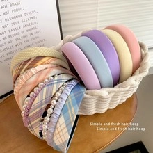 Collection of pastel hair hoops with pearls and plaid patterns in a woven basket
