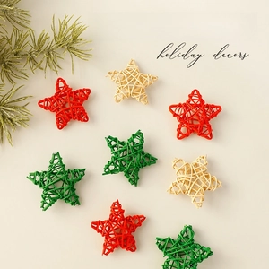Handmade Christmas rattan star ornaments in red, green and natural colors on white backdrop