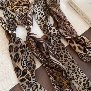 Detail of retro chiffon scarf necklace with leopard and animal print patterns