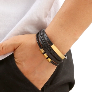 Men's multilayer black braided leather bracelet with gold metal beads on model's wrist