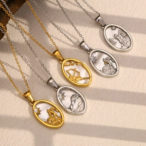 Detailed view of 18K gold and silver zodiac pendants with shells and crystal accents