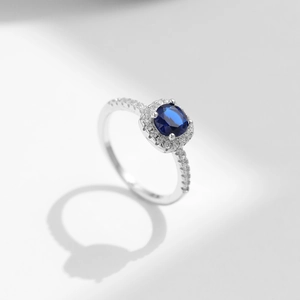 S925 sterling silver geometric ring with sparkling deep blue center stone and side halo