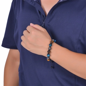 Detail of 10mm tiger eye beaded bracelet worn by model with adjustable black cord
