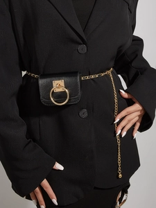 Close-up of black belt pouch with gold circular buckle and chain on a black suit