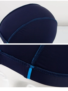 Detail of navy blue swim cap featuring professional flatlock stitching and elastic fabric