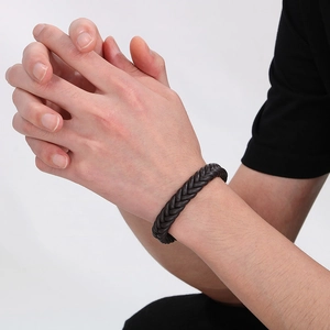 Men's dark brown braided leather bracelet with stainless steel clasp on wrist